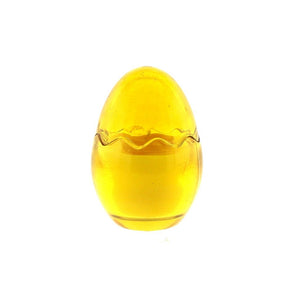 The Yellow Glass Easter Egg w/ Yoke is an egg-shaped yellow glass paperweight with a wavy line around its middle, reminiscent of an Easter egg candle, displayed against a white background.