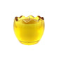 The Yellow Glass Easter Egg w/ Yoke features a scalloped yellow glass holder with an egg-shaped natural wax candle, its white wick perfectly centered inside.