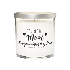 The "You're the mom everyone wishes they had" White Glass Candle in a jar with silver lid makes a perfect heartfelt gift for moms.