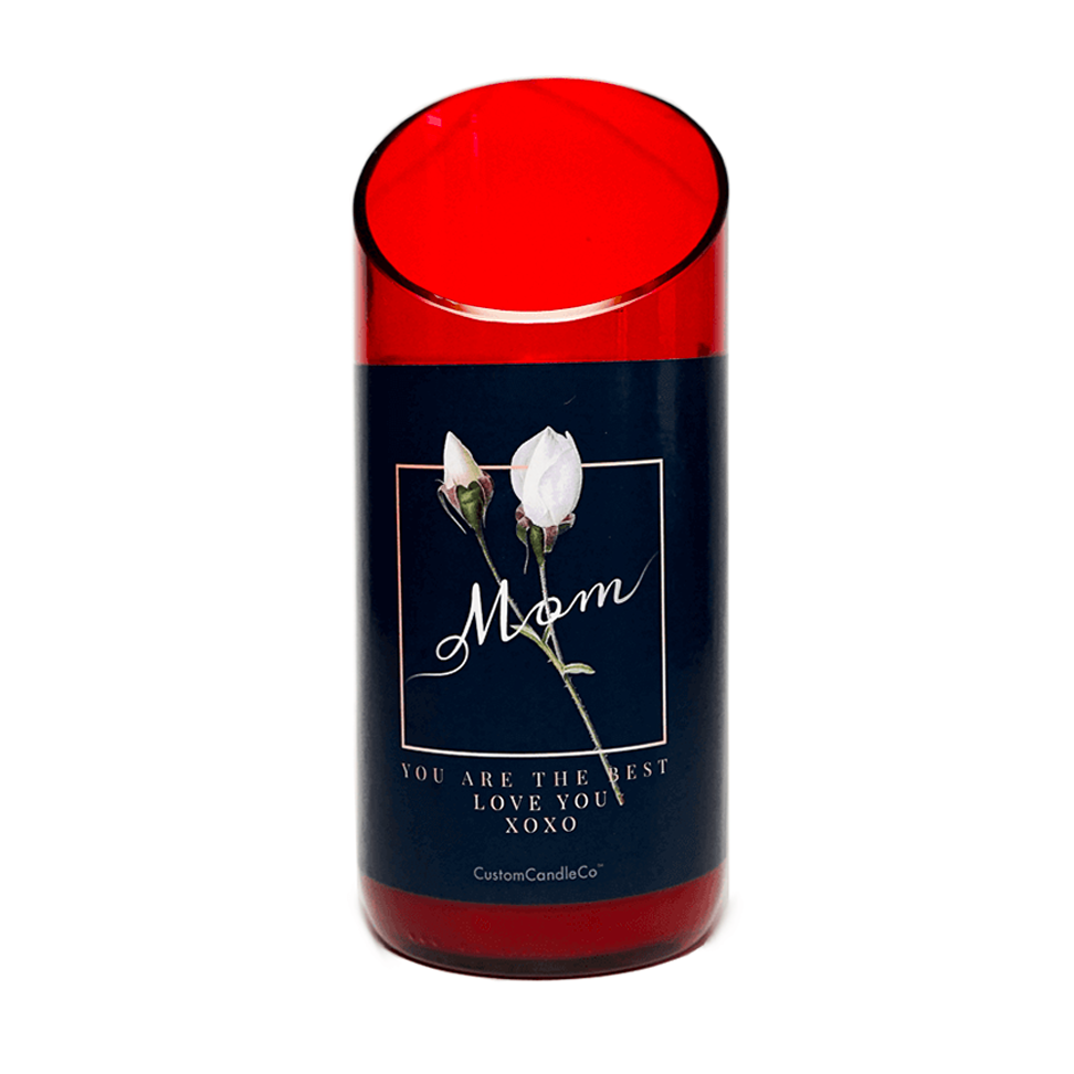 The "Mom You're the Best" Candle is a custom red glass candle holder featuring a floral design and the words “Mom, You are the best, love you XOXO” printed on the front.
