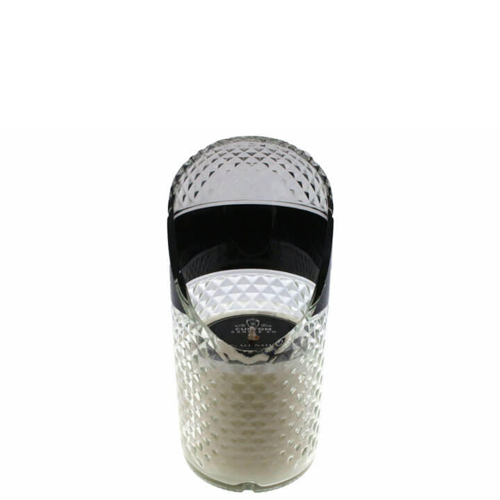 A cylindrical perfume bottle with a black cap and label sits beside the Recycled Black Label Vodka Candle, a custom-scented candle crafted from natural soy wax, both set against a white background.