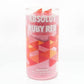 The Recycled Ruby Vodka Candle is a clear glass upcycled from Absolut Ruby Red vodka branding with geometric red and orange shapes, hand poured with pink natural soy wax.