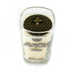 The Recycled Mexican-Style Silver Tequila Candle is a white soy candle in a clear glass holder crafted from an Avión Silver Tequila bottle, topped with a black and gold geometric-patterned lid—adding unique style to any space.