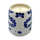 The Recycled Azul Tequila Candle is a hand-poured soy candle in a ceramic holder with blue floral patterns, showcased on a plain white background.