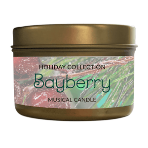 A gold tin labeled "Musical Holiday Candle – Bayberry" rests amid bayberries and pine needles, evoking the festive scent and spirit of holiday candles.