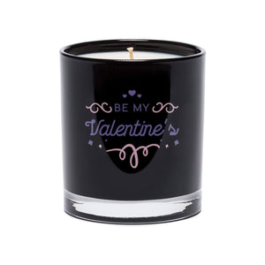 The Be My Valentine’s Quote Candle features a white candle in a black tumbler glass with "Be My Valentine’s" and a romantic quote on the front in decorative lettering.