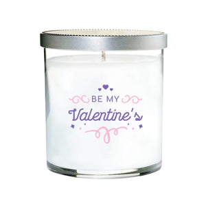The Be My Valentine’s Quote Candle comes in a clear tumbler glass with a silver lid, featuring purple and pink decorative text. Infused with essential oils, it’s perfect for adding a romantic touch this Valentine’s Day.