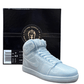 The AJ-1 Baby Blue Sneaker Candle – Large (On Backorder), hand poured with a Black Ice fragrance, is shown in front of a black "Custom Candle Co." box featuring product details on the side.