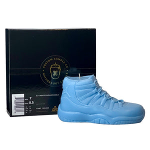 The AJ-11 Baby Blue Hightop Sneaker Candle – Large (On Backorder) is shown in front of a black “Custom Candle Co. Natural Soy Candle” box. Each candle is hand poured for a unique, stylish touch.