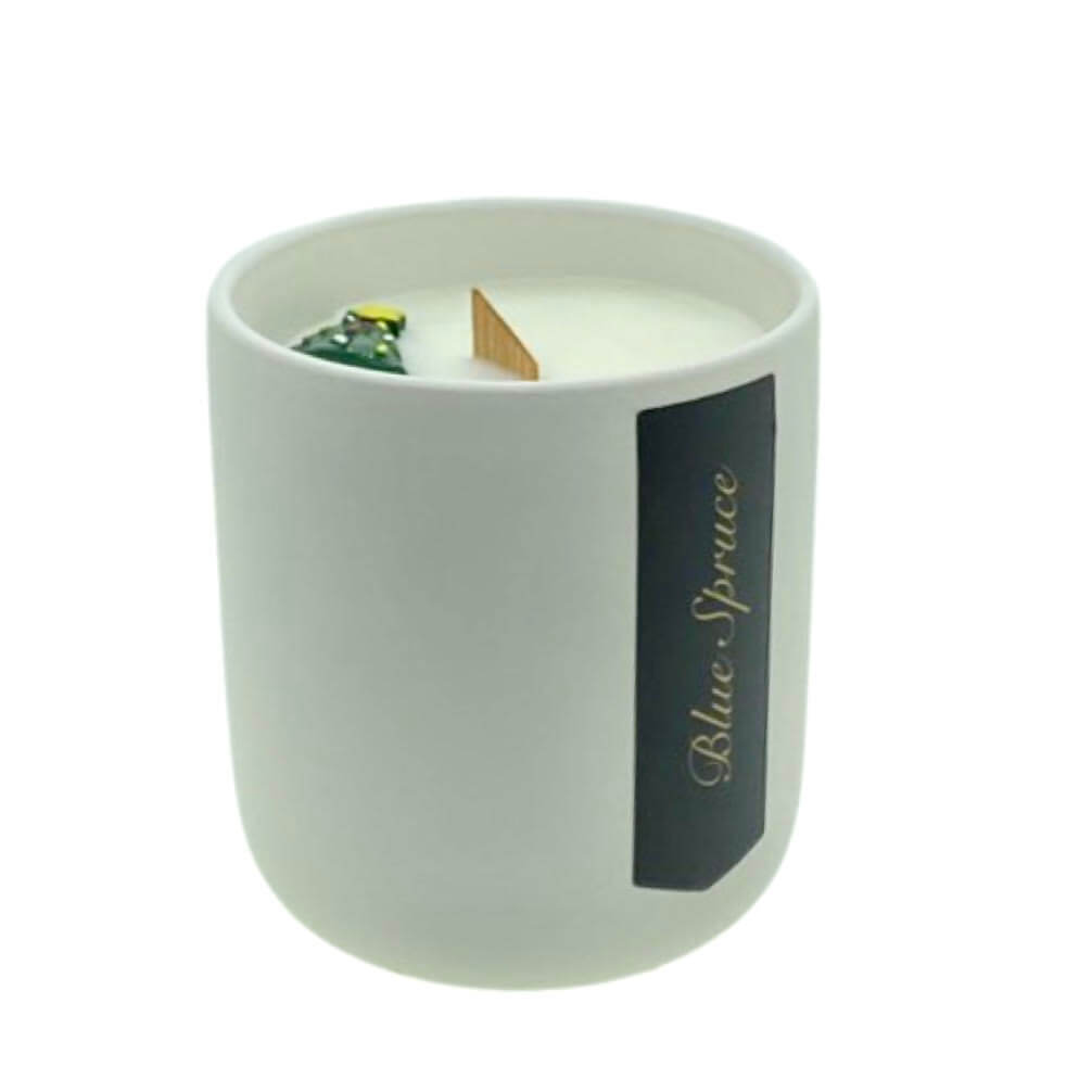 The Holiday Scented Boxed Candle – Blue Spruce Scent features white soy wax in a plain ceramic holder with a wooden wick and green ornament—labeled "Blue Spruce"—ideal as a festive candle with its seasonal fragrance.