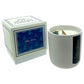 The Holiday Scented Boxed Candle – Blue Spruce Scent features a white soy wax candle in a white container beside its coordinating blue and white box, delivering a festive holiday fragrance.