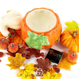 The Ceramic Large Leaf Pumpkin Candle, paired with artificial autumn leaves, small pumpkins, berries, and a Custom Candle Co. matchbox, sets a cozy scene—ideal for highlighting pumpkin spice or your favorite soy candle fragrance.