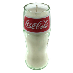 The Recycled Soda Bottle Candle is a hand-poured soy candle set in a clear glass designed to resemble a classic Coca-Cola cup, finished with a red Coca-Cola logo label.