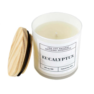 The EUCALYPTUS Relaxing Aromatherapy Candle 11oz features a white jar with "Eucalyptus" label, wooden lid, and contains 100 mg CBD with natural soy wax for a soothing CBD aromatherapy experience.