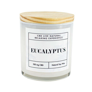 The EUCALYPTUS Relaxing Aromatherapy Candle 11oz is a natural soy candle with 100mg CBD in a glass jar and wooden lid, perfect for soothing relaxation.