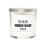 The “You are My Hero Dad” candle is a white natural soy candle in a clear glass jar with a silver lid—a thoughtful custom gift for dad featuring “You are my hero dad” on the label and made by Custom Candle Co.