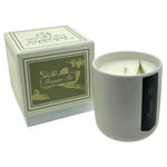The Holiday Scented Boxed Candle – Frasier Fir Scent is a white soy wax candle in a ceramic container with gold and green accents, paired with a matching box—ideal for adding festive fragrance to your home.