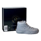 The AJ-11 Gray Hightop Sneaker Candle – Large (On Backorder), hand poured with Black Ice fragrance, sits in front of a black "Custom Candle Co." box showing product and size information.