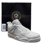 The AJ-4 Gray Sneaker Candle – XL, shaped like a gray sneaker, is shown before a black "Custom Candle Co. Natural Candle" box and features the fresh Black Ice scent; this unique hand-poured candle is currently on backorder.