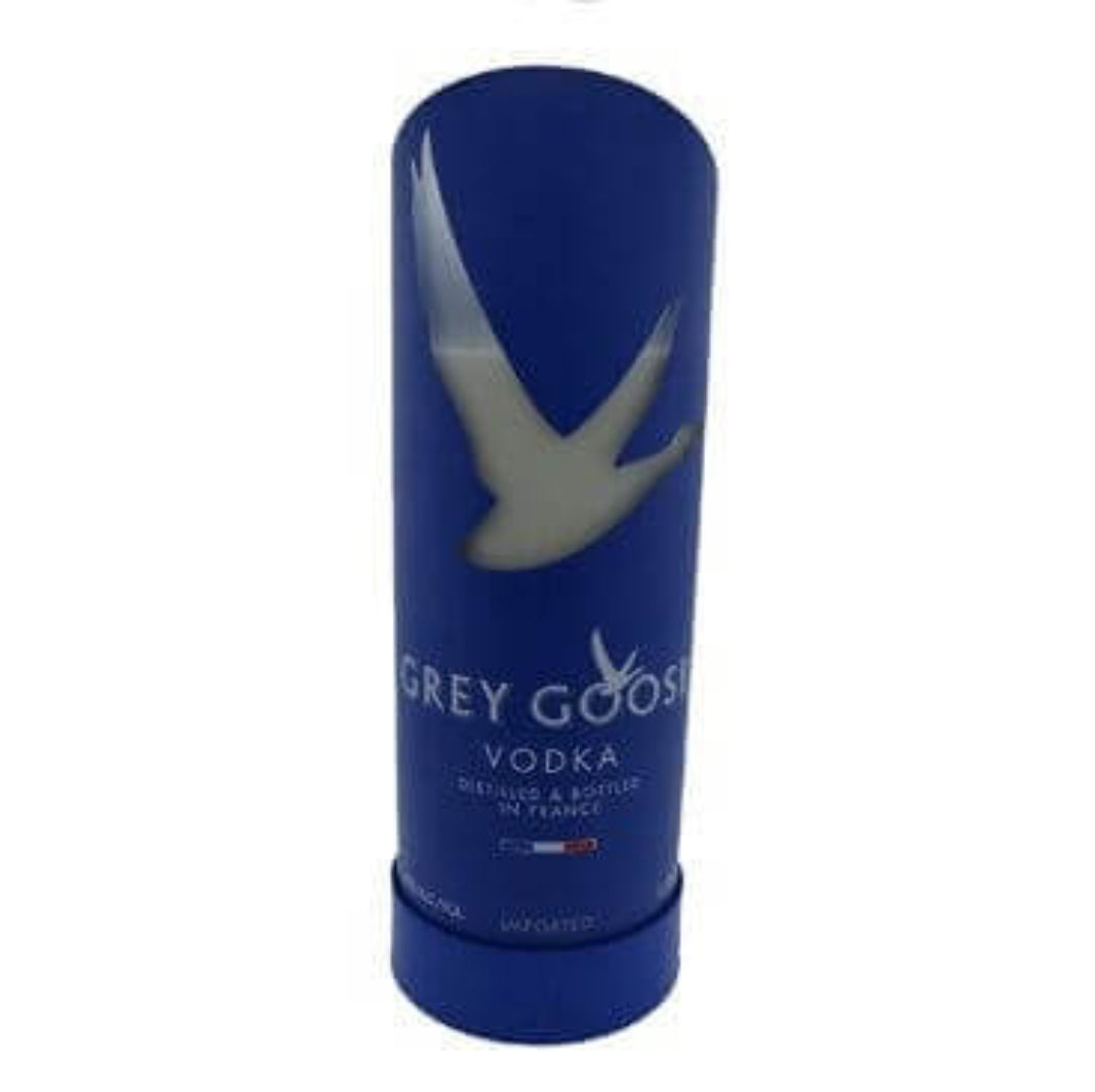 The Recycled French Vodka Candle - Blue features a tall, cylindrical blue container with a white goose silhouette and "Grey Goose Vodka" text, stylishly repurposed from recycled materials.