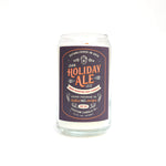 The Dark Holiday Ale Candle is a hand-poured, beer-scented candle crafted from natural soy in a clear glass, featuring a "Dark Holiday Ale" label and designed to look like a classic 12 oz beer can.