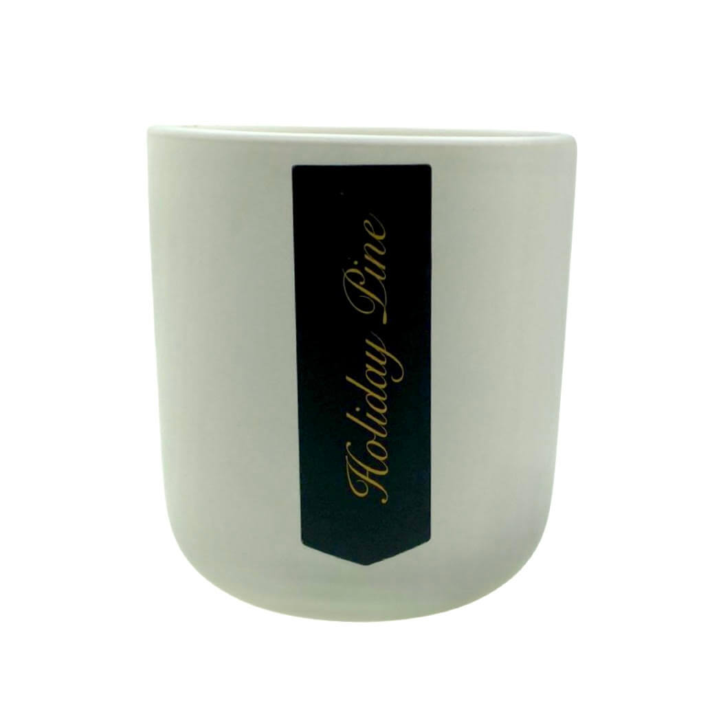 The Holiday Scented Boxed Candle – Holiday Pine Scent features a white ceramic container with a black "Holiday Pine" gold-script label and is made from a natural soy wax blend for a clean, festive fragrance.