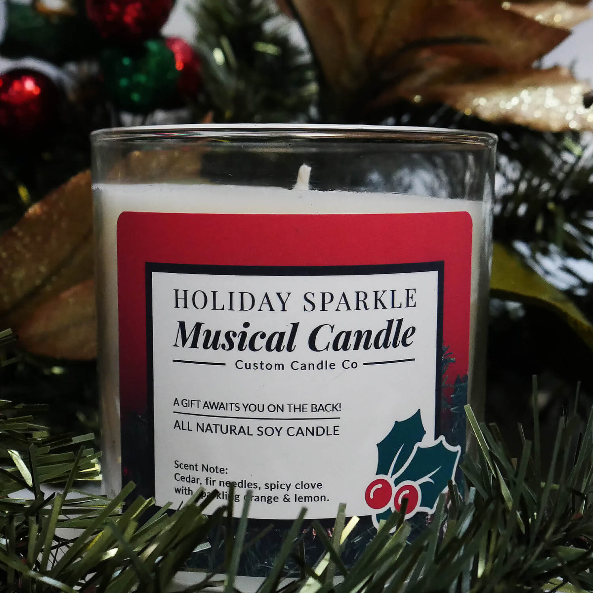 The Musical Holiday Candle – Holiday Sparkle is a glass jar soy candle displayed with festive décor, ideal for anyone who enjoys musical Christmas candles.