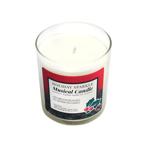 The Musical Holiday Candle – Holiday Sparkle is a white soy candle in a clear glass jar with a festive red label and holiday decorations, offering delightful music and aroma for a cheerful Christmas atmosphere.