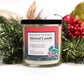 The Musical Holiday Candle & Diffuser | Holiday Sparkle features festive decorations, a black lid, and sits among greenery and berries—a delightful scented soy candle perfect for holiday celebrations.