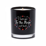 The "I Love You to the Moon and back" Quote Candle comes in a black tumbler glass, featuring white text and decorative accents in red, purple, and pink.