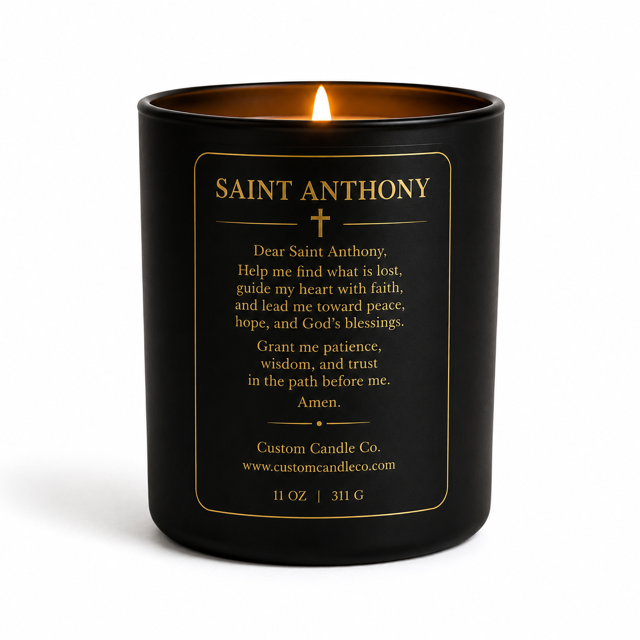 The Saint Anthony Prayer Candle is a black 11 oz (311 g) candle featuring a gold-printed prayer and product details on the label, offering spiritual comfort.