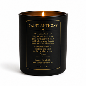 The Saint Anthony Prayer Candle is a black 11 oz (311 g) candle featuring a gold-printed prayer and product details on the label, offering spiritual comfort.