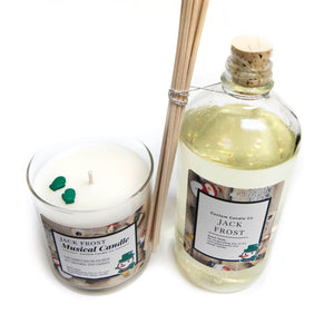 The Musical Holiday Candle & Diffuser | Jack Frost set includes a glass candle, diffuser oil bottle, and reed sticks on a white background—ideal for fans of festive, musical Christmas candles.