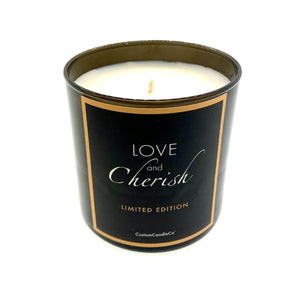 A black tumbler jar candle labeled "Love and Cherish Limited Edition" from CustomCandleCo, hand-poured and shown on a white background.