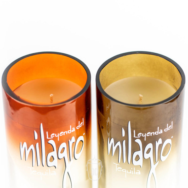 The Recycled Sunset-Colored Reposado Tequila Candle is crafted from Milagro Tequila bottles in vibrant orange and yellow—eco-friendly, unique décor for tequila lovers.