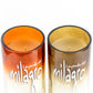 Two Recycled Desert-Colored Tequila Candles, made from repurposed tequila bottles, display orange and cream soy wax side by side on a white background.