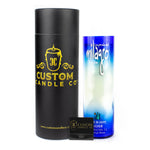 A black Custom Candle Co. cylindrical box, a Recycled Blue Agave Tequila Candle in a blue and white bottle, and a small black matchbox are displayed side by side on a white background.
