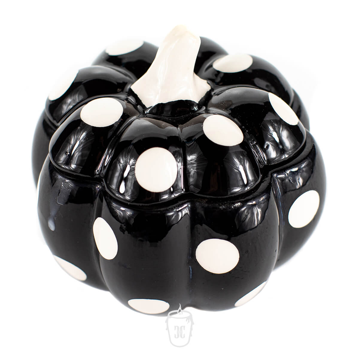 The Ceramic Mini Polka Black Pumpkin Candle features a black ceramic design with a white stem and large white polka dots—ideal for holding your favorite soy or scented candle.