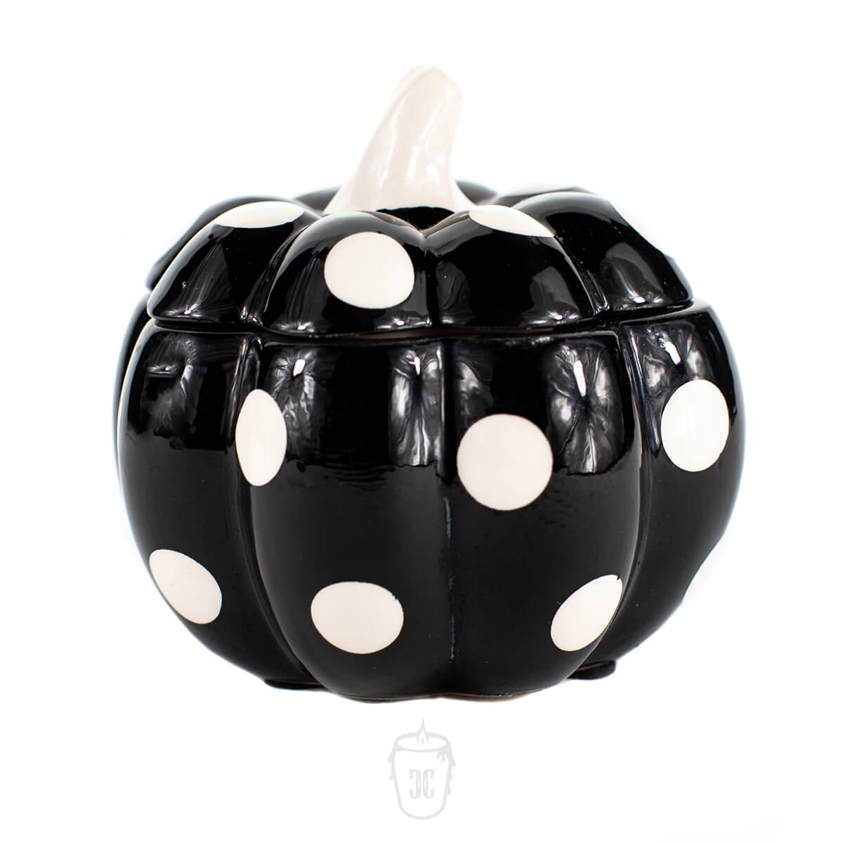 The Ceramic Mini Polka Black Pumpkin Candle features a black ceramic pumpkin with white polka dots and a white stem, making it a charming soy-scented accent for any space.