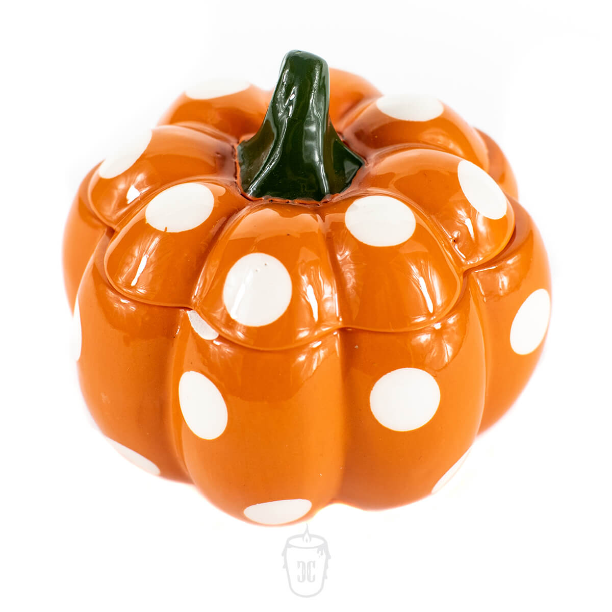 The Ceramic Mini Polka Orange Pumpkin Candle features a pumpkin-shaped orange ceramic container with large white polka dots and a green stem, ideal for holding candles, displayed against a plain white background.