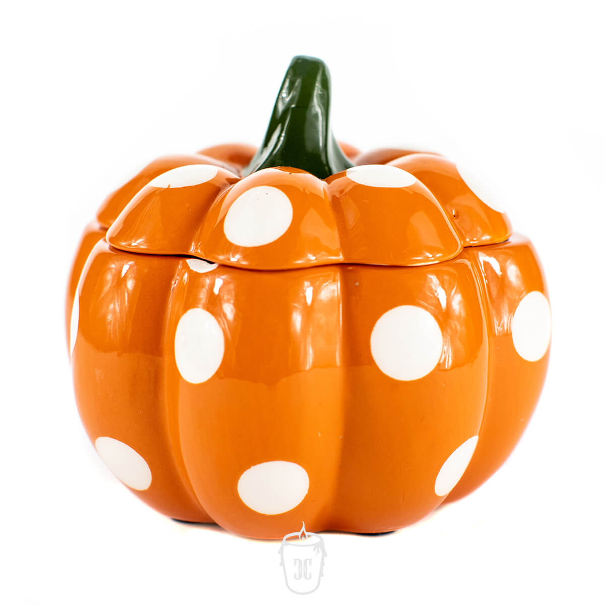 The Ceramic Mini Polka Orange Pumpkin Candle features an orange ceramic pumpkin with white polka dots and a green stem, displayed against a white background. This charming candle is perfect for adding autumn décor to any space.