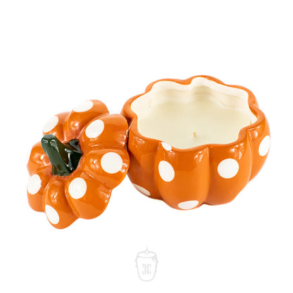 The Ceramic Mini Polka Orange Pumpkin Candle features an orange ceramic design with white polka dots and a removable lid, shown open beside it—ideal for showcasing your favorite soy candles.