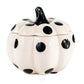 The Ceramic Mini Polka White Pumpkin Candle features a white ceramic container with large black polka dots and a black stem, perfect for holding soy candles or your favorite scented candle. Shown on a white background.