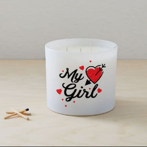 The My Girl Quote Candle (Frosted tumbler jar) features "My Girl" and a red heart with an arrow, hand poured from soy wax, displayed on a light wooden surface beside three matches.