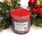 A Musical Holiday Candle & Diffuser | Peppermint in a glass jar rests among faux pine and berries, featuring a festive label—perfect for bringing cozy holiday cheer to your home this season.
