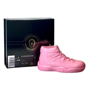 The AJ-11 Baby Pink Hightop Sneaker Candle – Large (On Backorder) is shown in front of a "Custom Candle Co. Natural Soy Candle" black box and features a fresh black ice fragrance.