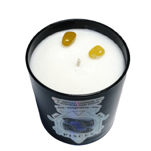The Zodiac: Pisces Candle features black with two yellow gemstones in white wax, placed on a white surface, and offers a calming Lemon Lavender scent.