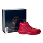 The AJ-11 Red Hightop Sneaker Candle – Large (On Backorder), hand poured from all natural wax, sits beside a black box with sizing and Custom Candle Co. branding.