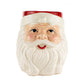 The Santa Claus Holiday Candle is a hand-poured soy candle in a ceramic mug shaped like Santa's face, with a red hat, white beard, and rosy cheeks, displayed against a plain white background.