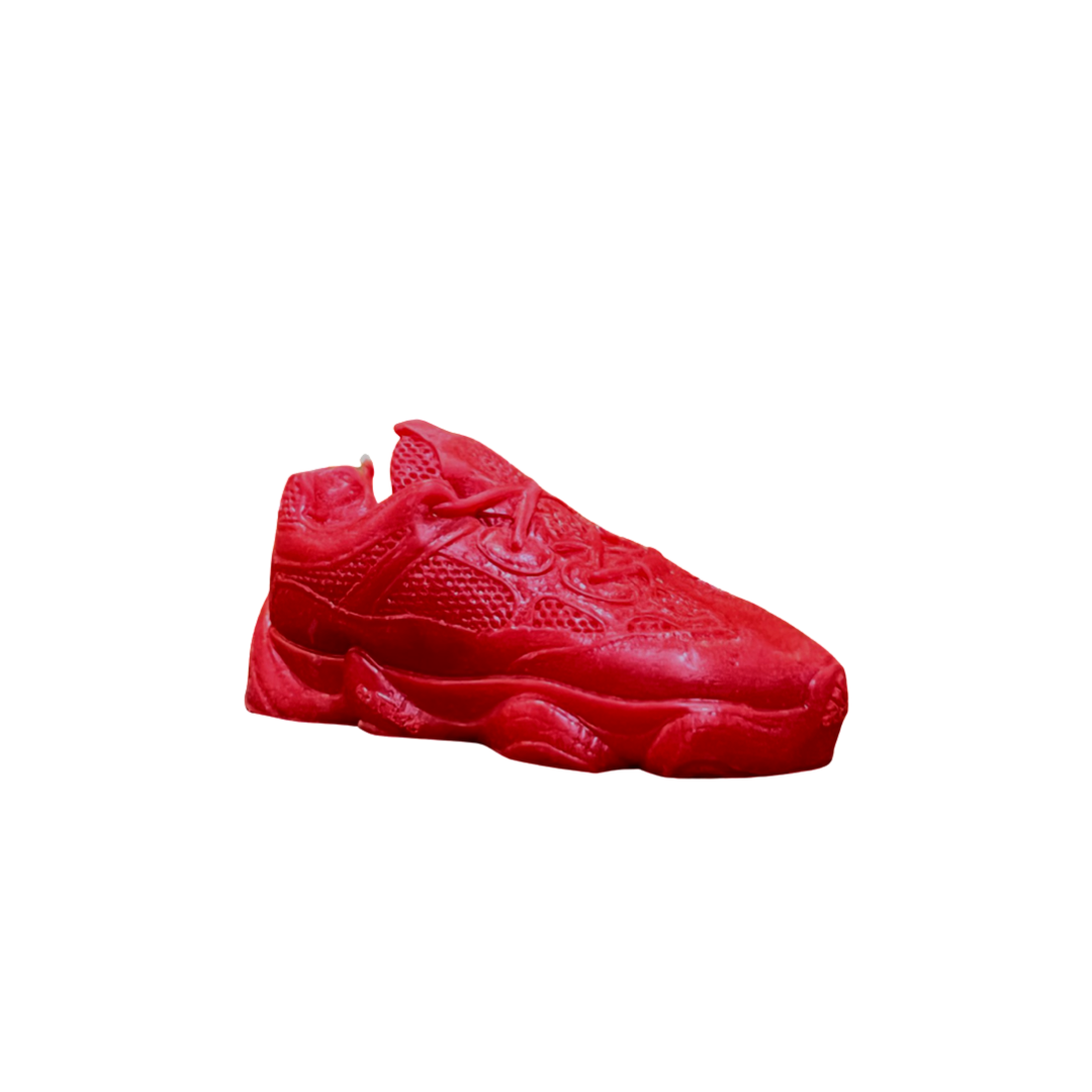 The Y500 – Red Sneaker Candle – Small (On Backorder) is a red, sneaker-shaped candle hand poured from natural wax and displayed against a white background.